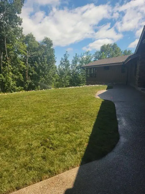 Wide open field of newly established grass from a KBK Landscaping seeding project